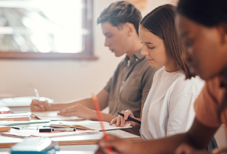 Education, writing and exam with students in classroom of colleg